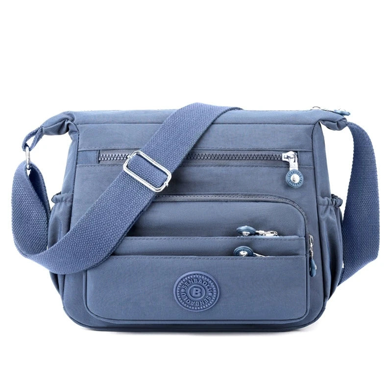 حقيبة كروسبودي أنيقة وخفيفة الوزن من النايلون للنساء، مزودة بحزام قابل للتعديل وتصميم متعدد الجيوب للسفر والتسوق والمواعيد والمدرسة