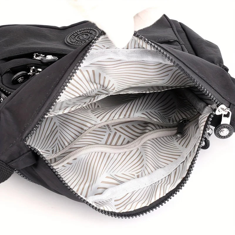 حقيبة كروسبودي أنيقة وخفيفة الوزن من النايلون للنساء، مزودة بحزام قابل للتعديل وتصميم متعدد الجيوب للسفر والتسوق والمواعيد والمدرسة