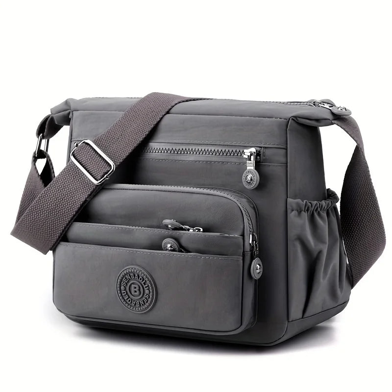 حقيبة كروسبودي أنيقة وخفيفة الوزن من النايلون للنساء، مزودة بحزام قابل للتعديل وتصميم متعدد الجيوب للسفر والتسوق والمواعيد والمدرسة