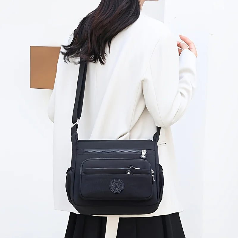 حقيبة كروسبودي أنيقة وخفيفة الوزن من النايلون للنساء، مزودة بحزام قابل للتعديل وتصميم متعدد الجيوب للسفر والتسوق والمواعيد والمدرسة