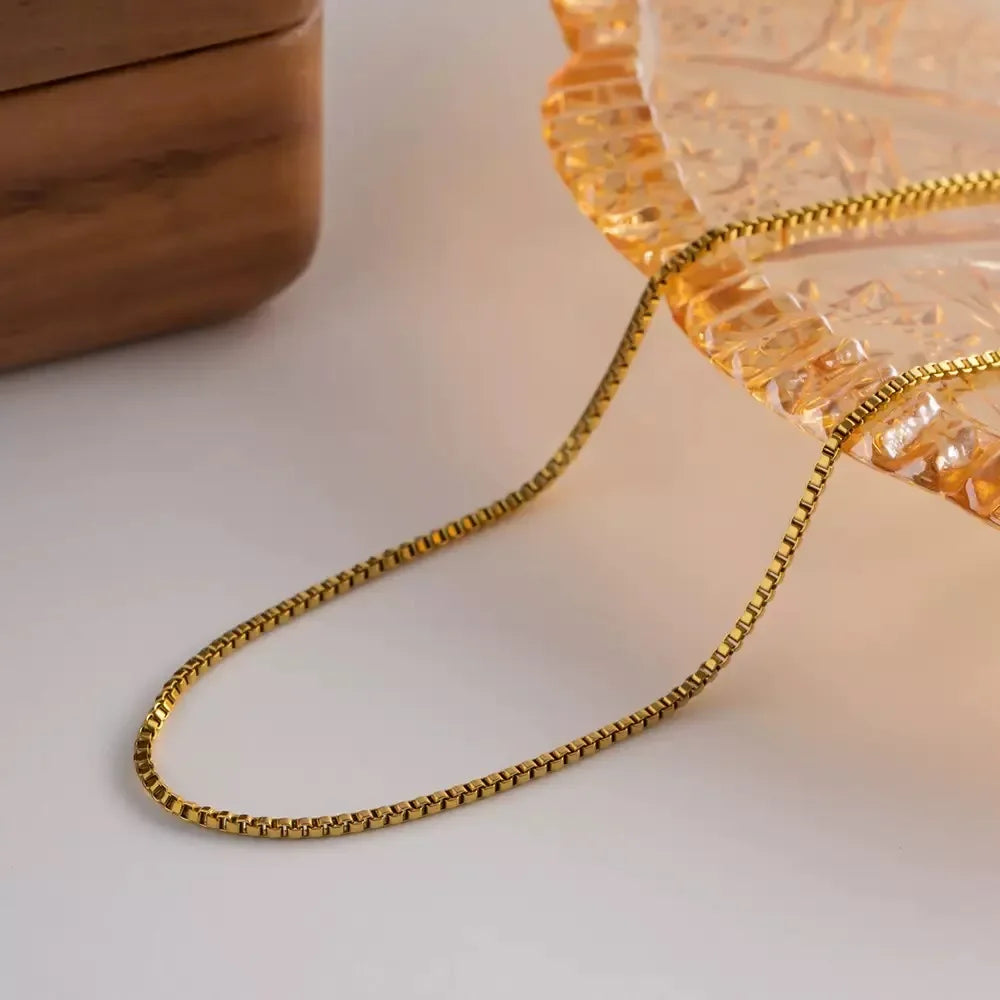 Delicate and timeless, this 925 sterling silver necklace features a sleek 1mm box chain finished in a rich gold plating. Its clean, minimalist design makes it the perfect foundation piece—lightweight yet durable, with a smo