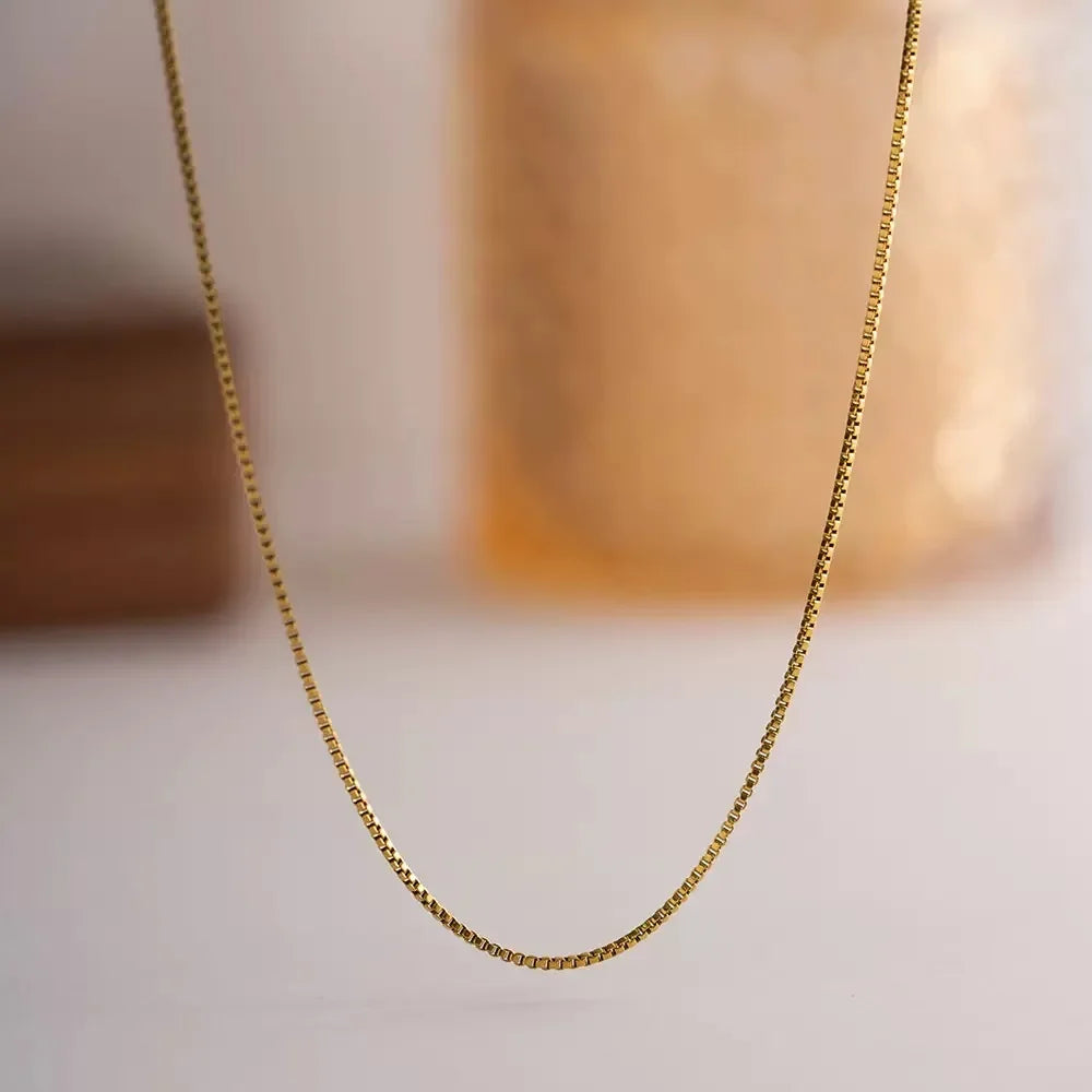 Delicate and timeless, this 925 sterling silver necklace features a sleek 1mm box chain finished in a rich gold plating. Its clean, minimalist design makes it the perfect foundation piece—lightweight yet durable, with a smo